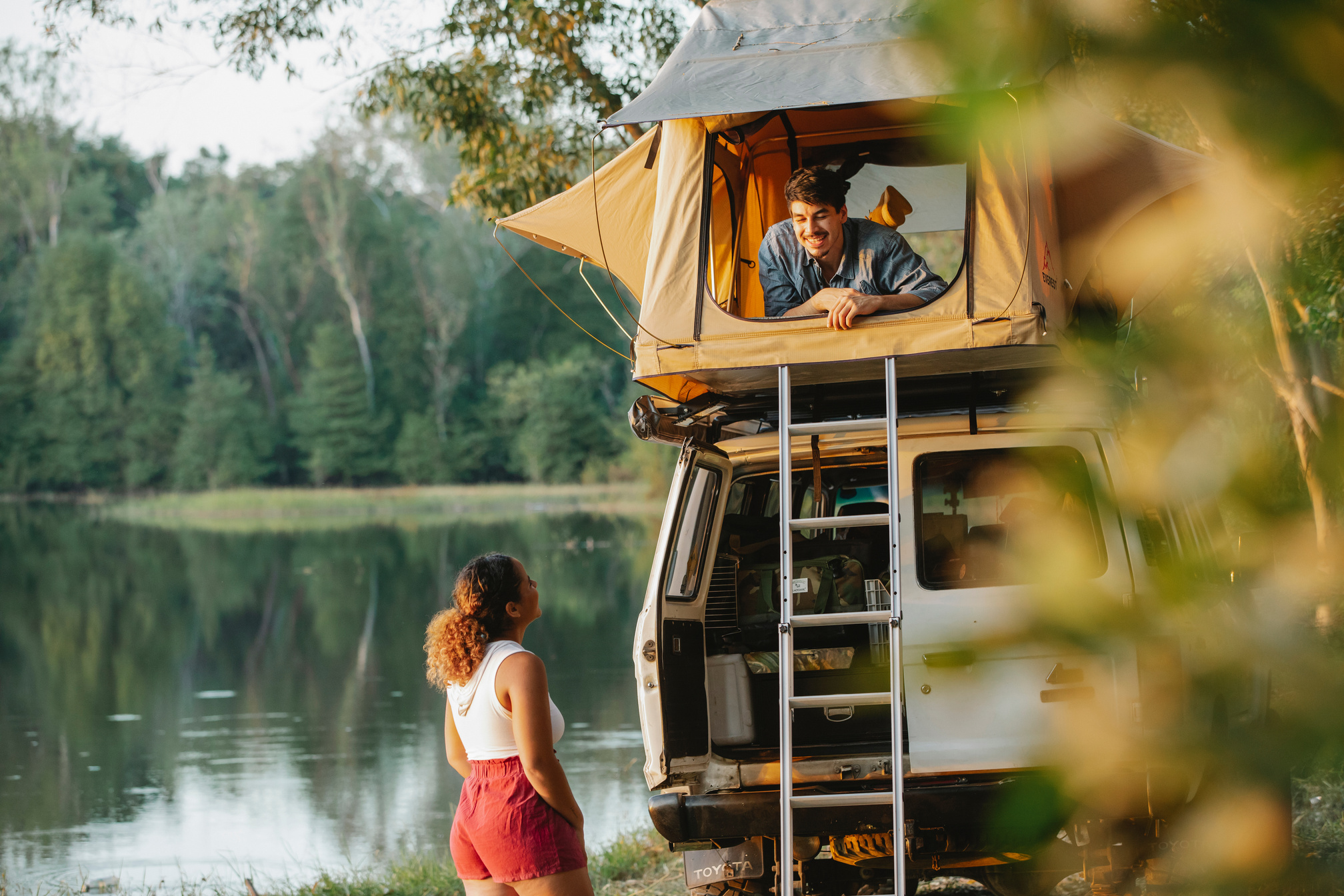Couple enjoying camping together on lakeside